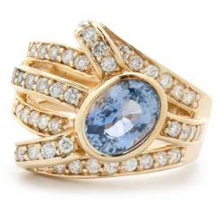 14 Karat Yellow Gold Bezel Set Cornflower Blue Sapphire and Diamond Bypass Ring