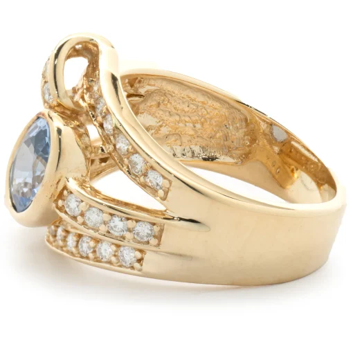 14 Karat Yellow Gold Bezel Set Cornflower Blue Sapphire and Diamond Bypass Ring